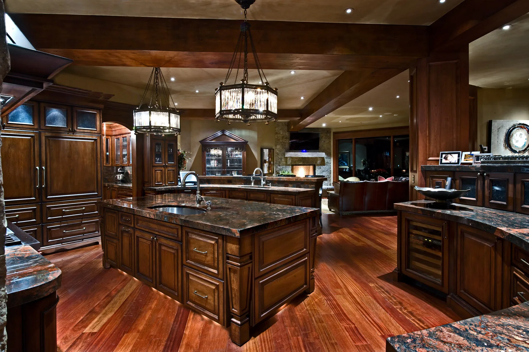 Kitchen with dark wood cabinetry, a large island and pendant lighting