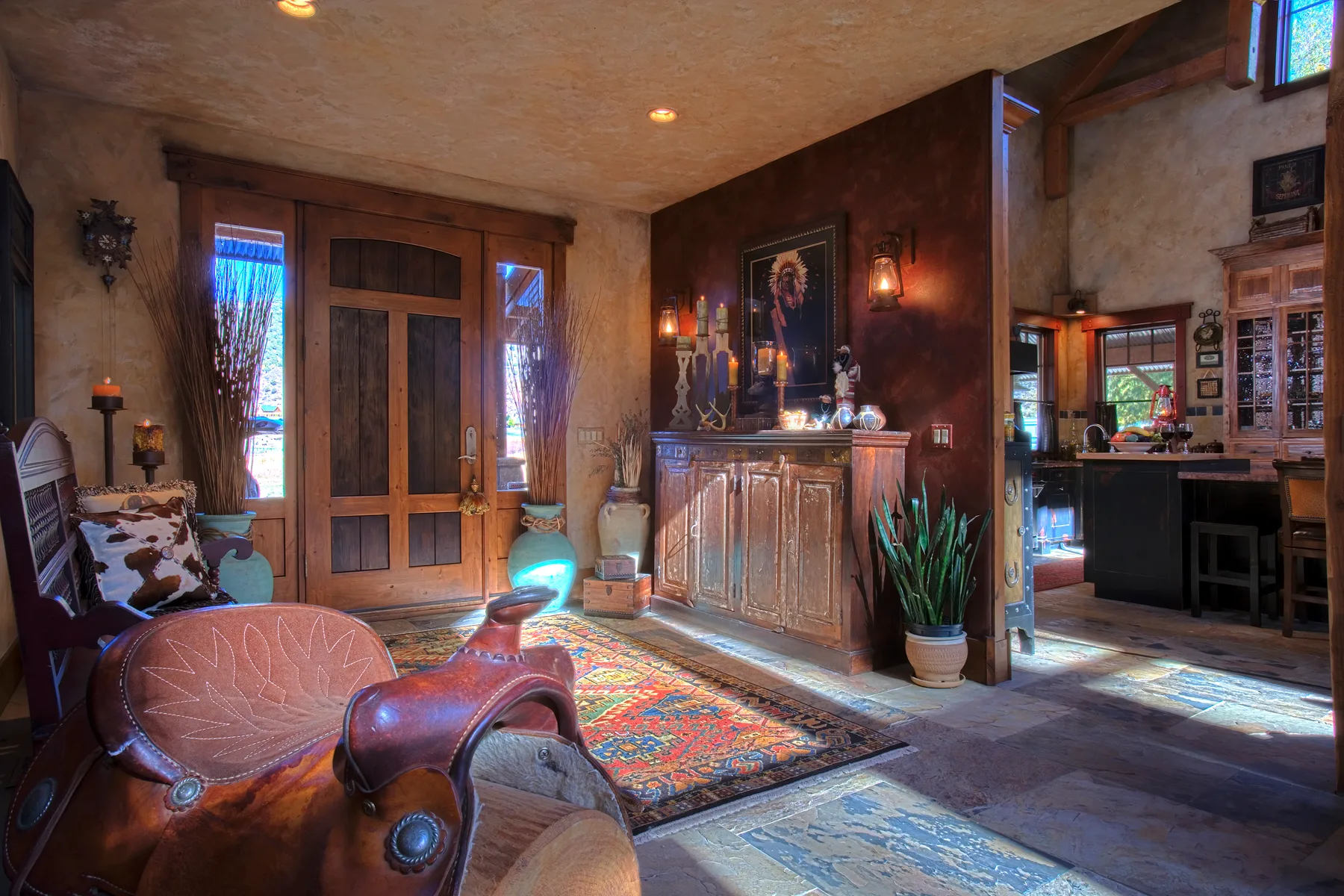Rustic entry with a leather saddle on a bench and French doors