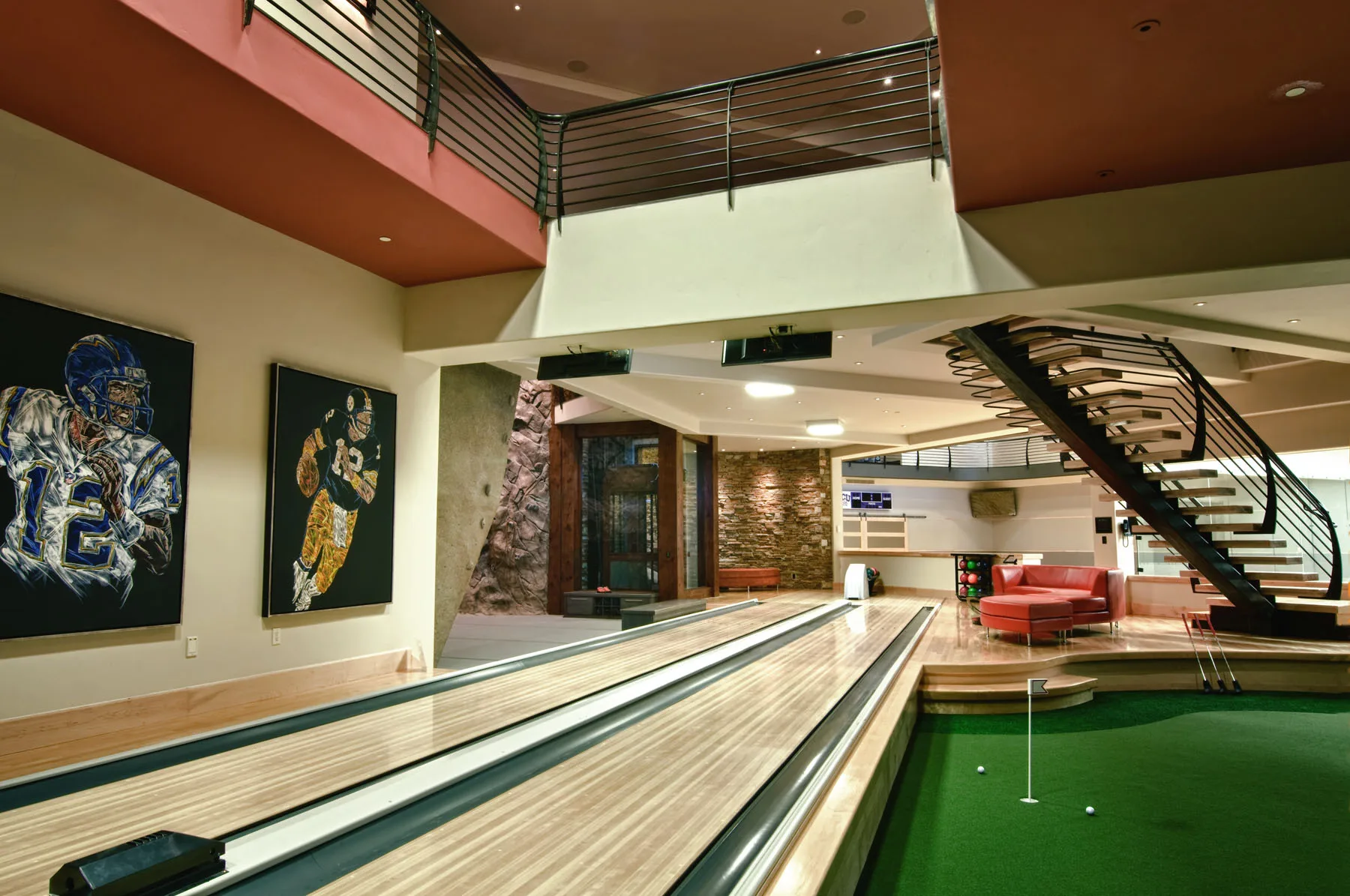 Private two-lane bowling alley with colorful artwork in a double-height space