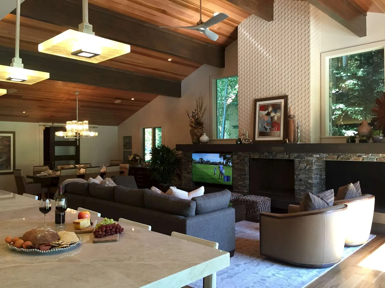 Living room with a stone fireplace and custom furniture pieces