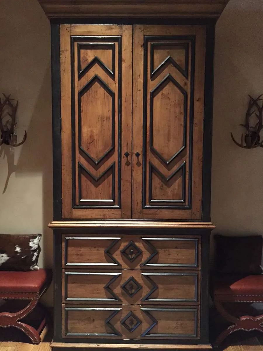 Custom dark wood armoire with carved door panels