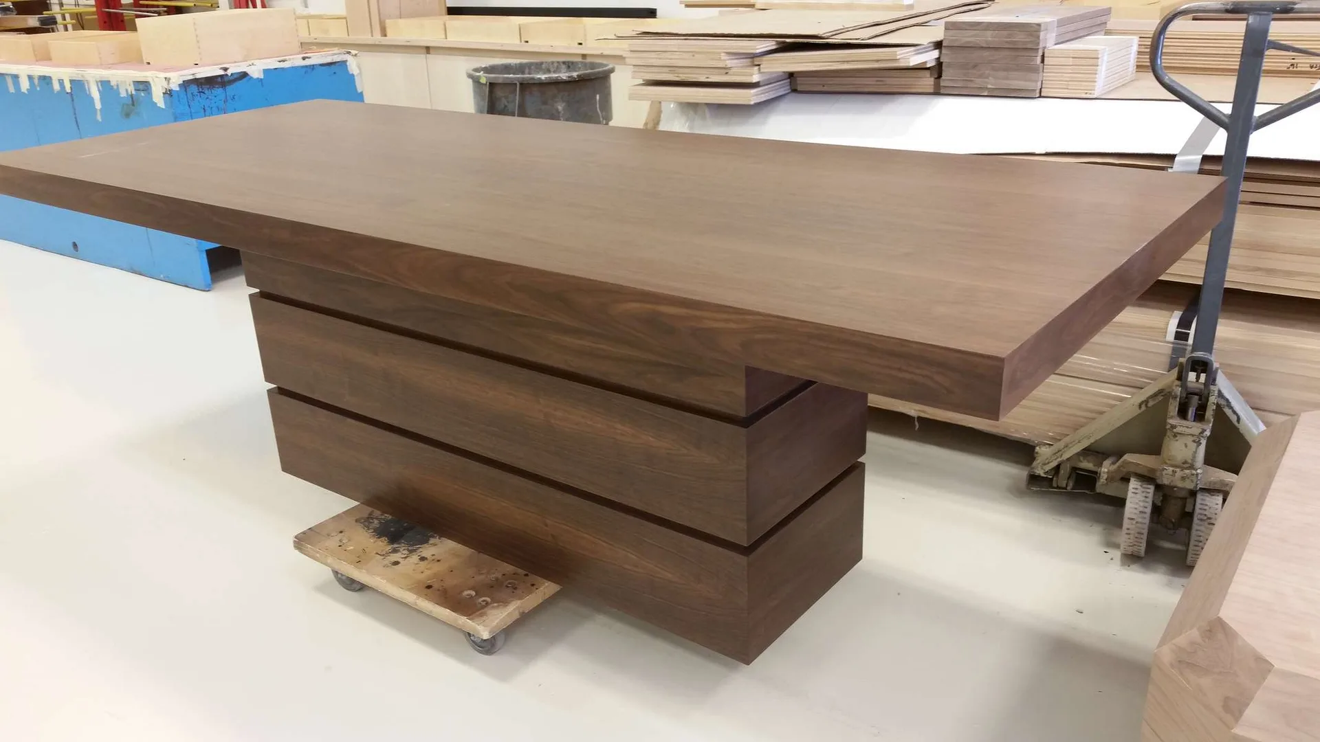 Custom wood table in progress on a workshop bench, partially sanded