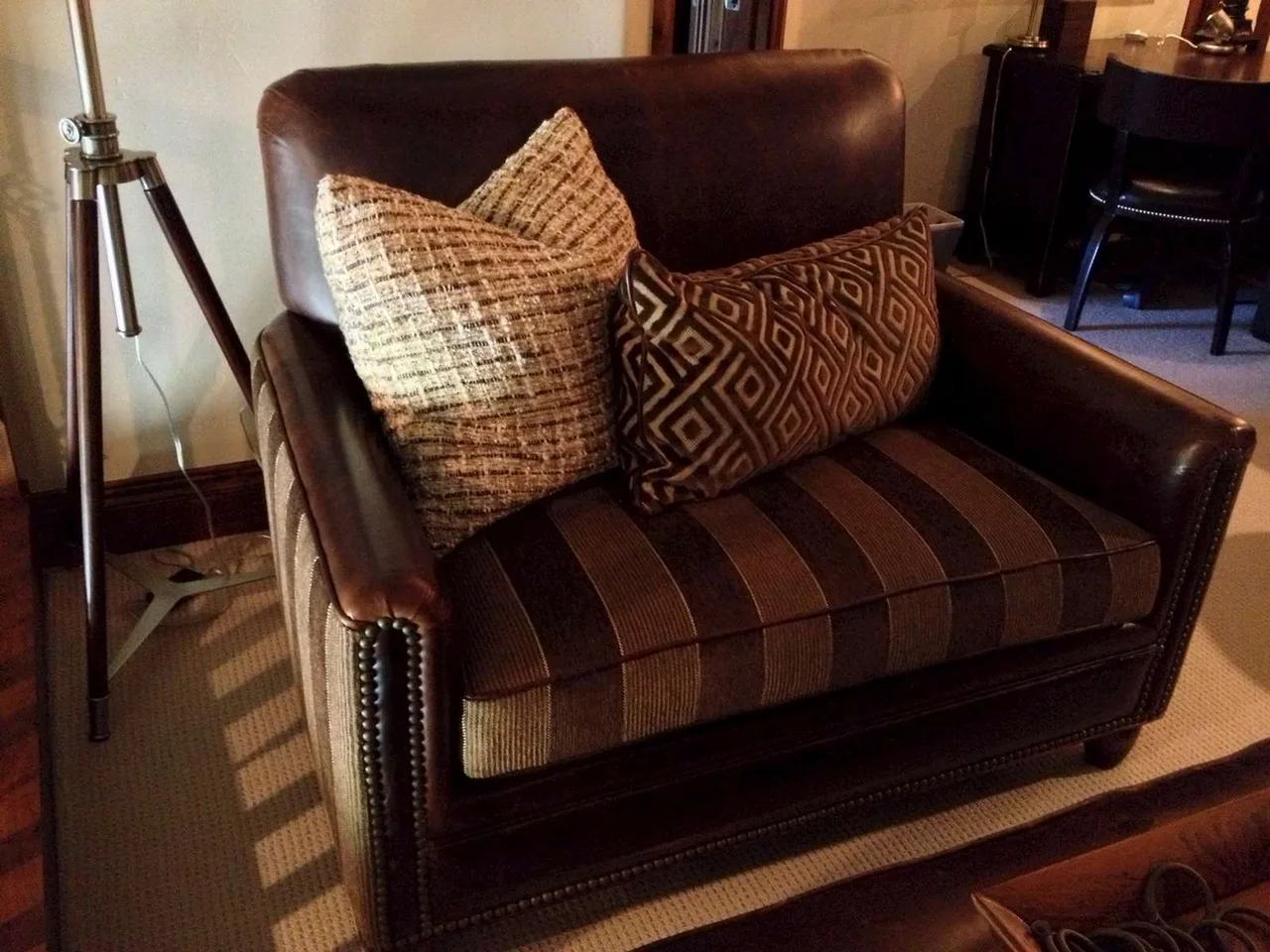 Custom striped upholstered armchair with throw pillows