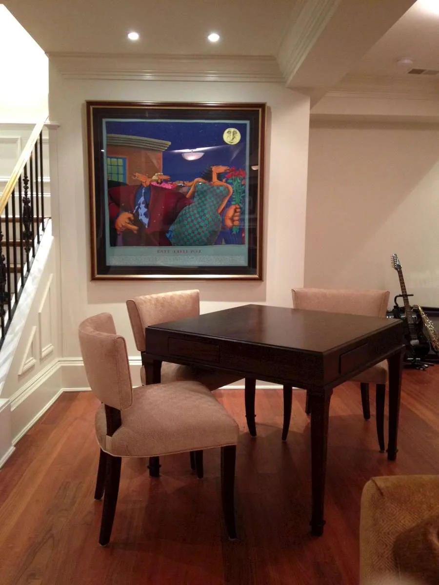 Sofa with a table lamp and side table, staircase visible in the background