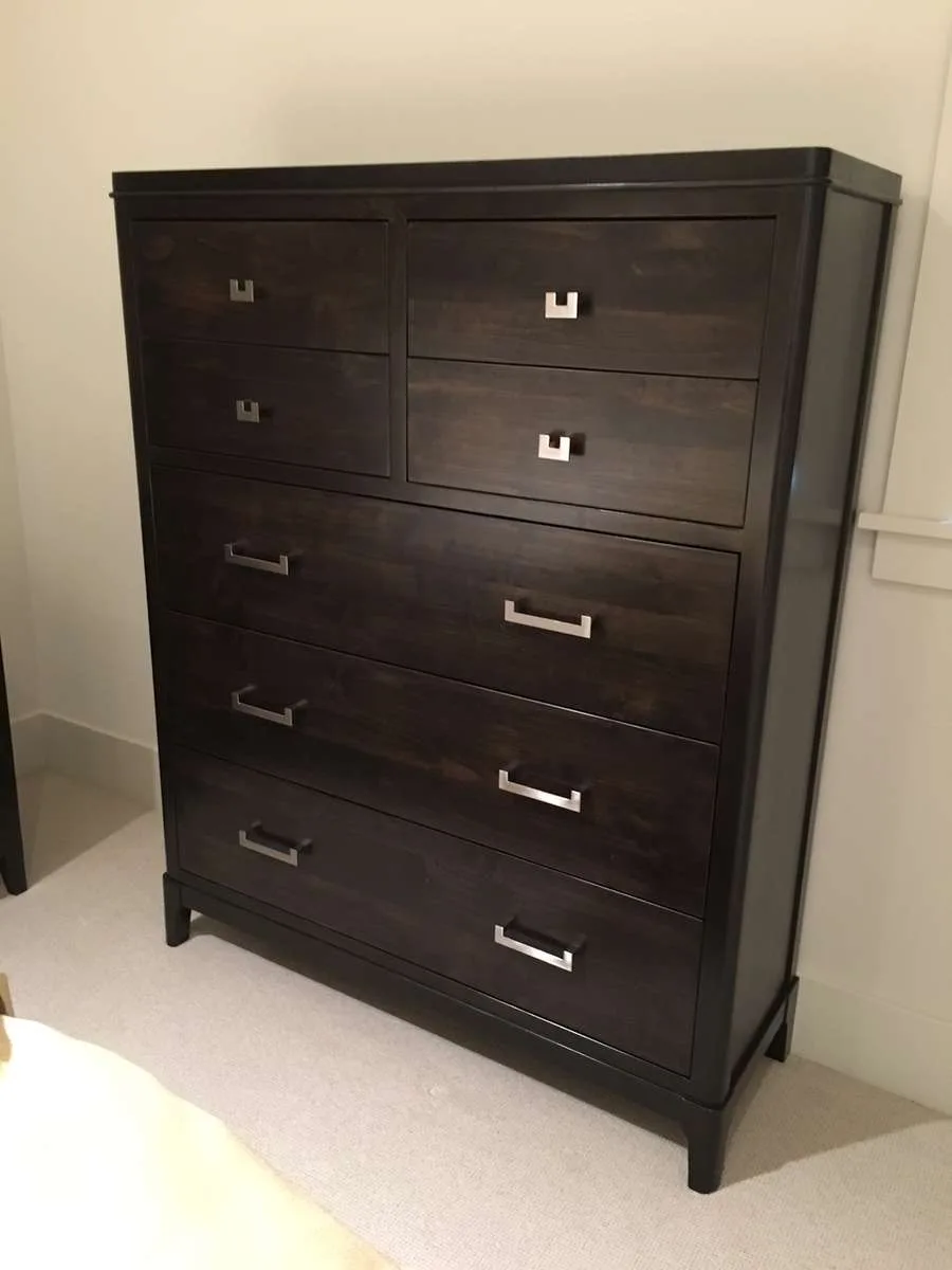 Custom dark wood nightstand with a decorative vase on top